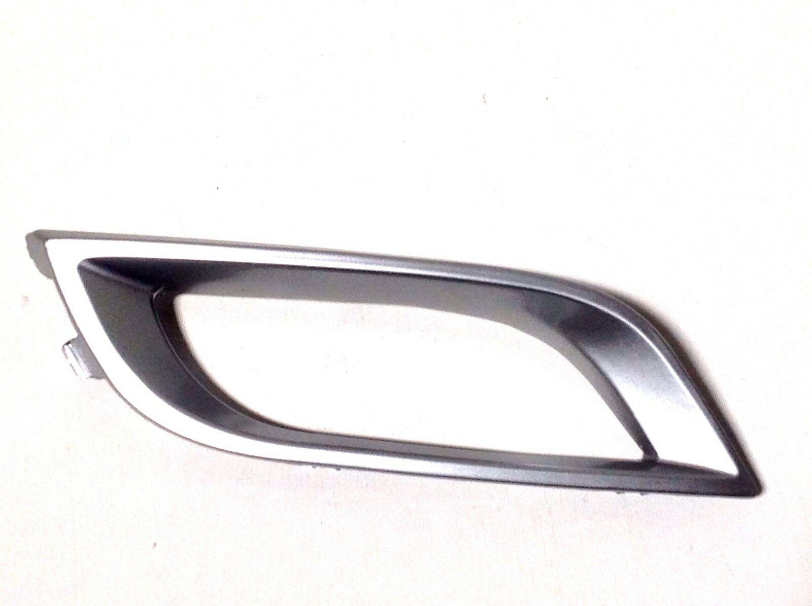 2010-2011 Mazda 3 Fog Lamp Bezel Front Passenger Side Mt 2.5L Silver , MA1039107. Angle view for visual reference.